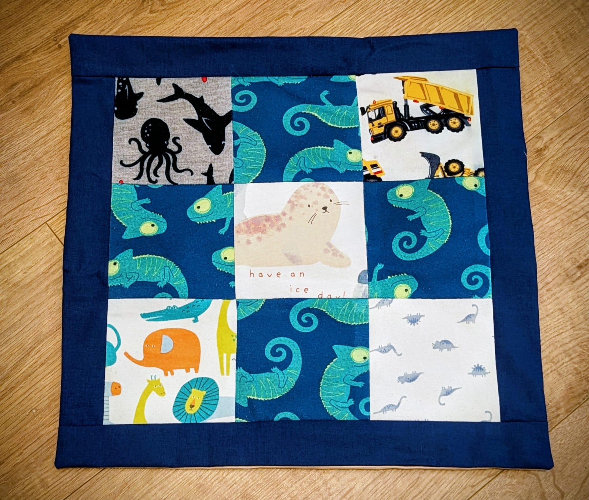 Close-up of navy patchwork cushion with animal prints