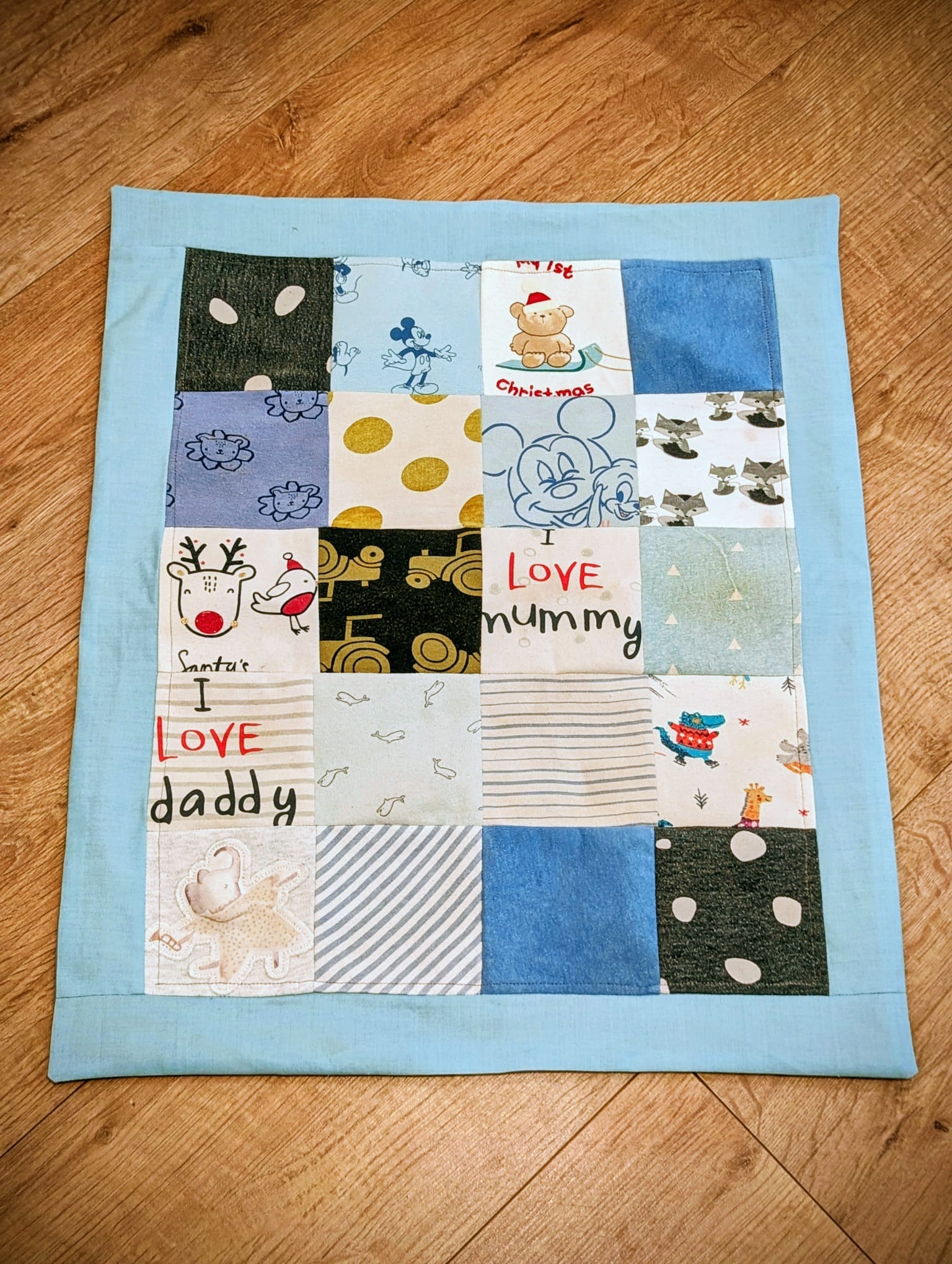 Light blue patchwork blanket flat lay showing full design